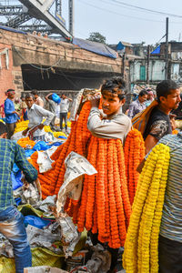 Rear view of people at market stall