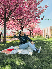 Side view of woman sitting on field