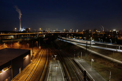 High angle view of railroad tracks against sky at night