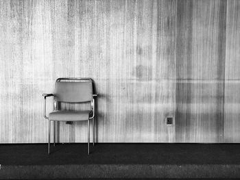 Empty chairs and table against wall at home