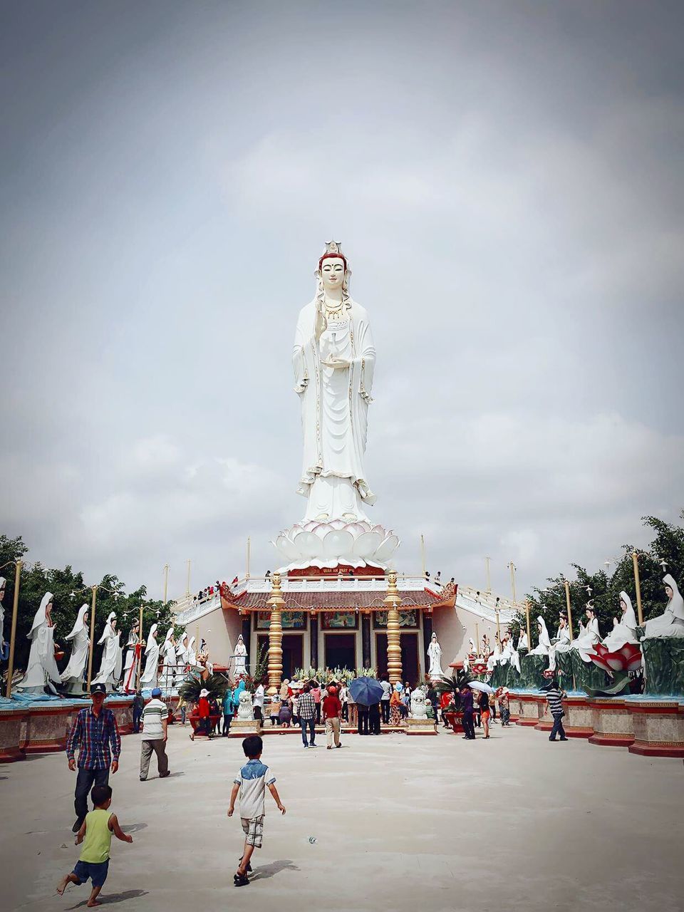 sky, architecture, built structure, human representation, statue, building exterior, art and craft, sculpture, religion, place of worship, art, spirituality, creativity, famous place, travel destinations, cloud - sky, travel, tourism