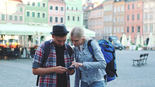 Young man using mobile phone in city