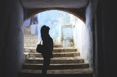 Silhouette woman in underpass