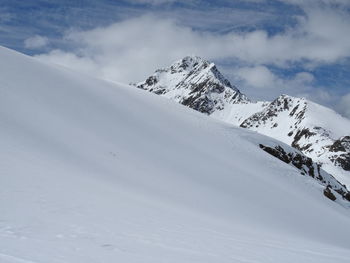 Scenic view of snow covered mountains against sky