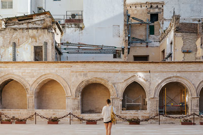 Young girl looking at a church's graveyard under construction