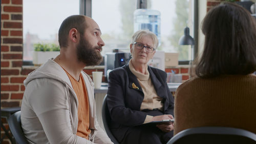 Side view of business colleagues working in office