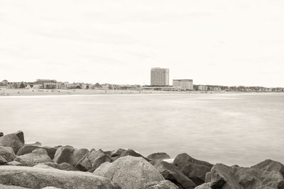 Scenic view of sea and buildings against sky