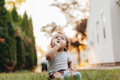 Portrait of diverse mixed race baby boy at home in backyard with golden hour sunset