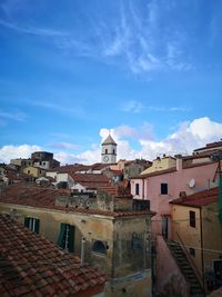 Buildings in town against blue sky