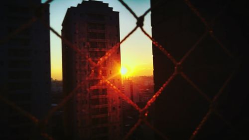 Close-up of city against sky during sunset