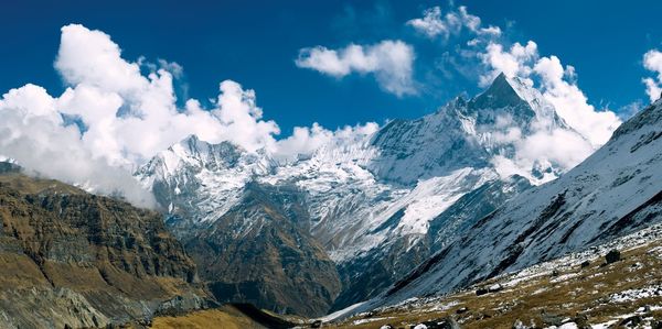 Panoramic view of snowcapped mountains against sky