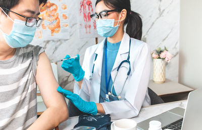 Midsection of women wearing hat