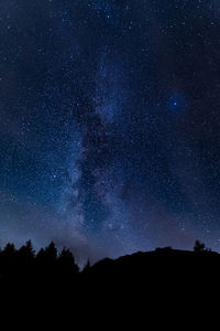 Low angle view of silhouette stars against sky at night