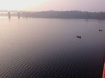 Scenic view of lake against sky at sunset