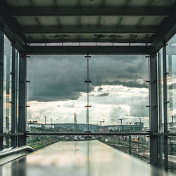 Bridge over river in city against sky