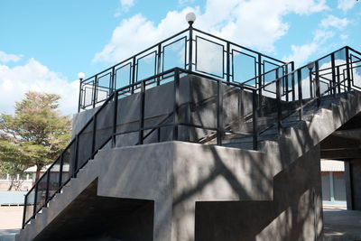 Low angle view of staircase by building against sky