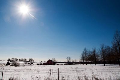 Scenic view of snow covered landscape against clear sky