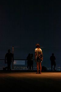 People standing on terrace clear sky at night