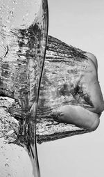 Close-up of water splashing in glass against white background