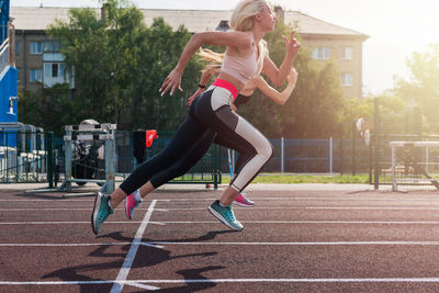 Full length of young woman exercising in park