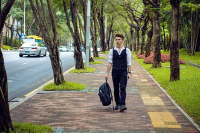 Rear view of man walking on street