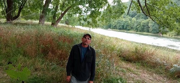 Portrait of smiling man standing on field