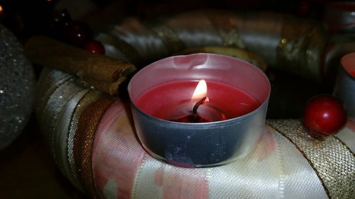 High angle view of tea light with christmas decorations on table