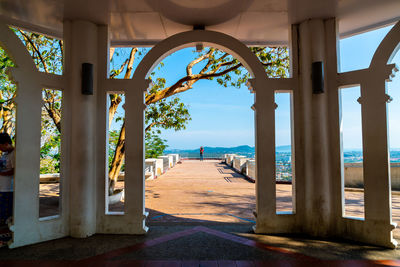 Scenic view of sea and building seen through window