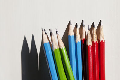 Close-up of colored pencils against white background