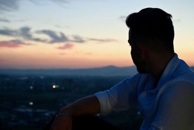 Portrait of young man looking at sunset
