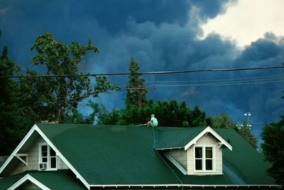 Low angle view of houses against cloudy sky