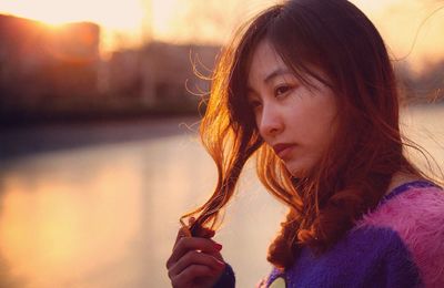 Close-up of thoughtful woman during sunset