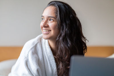 Close-up of young woman using mobile phone at home