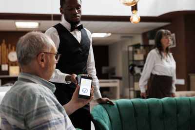 Side view of businessman using mobile phone