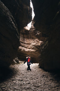 Rear view of woman walking on rock