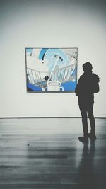 Side view of a man standing on tiled floor