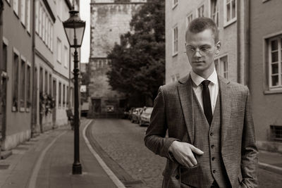 Portrait of saxophonist alexander prill standing in city