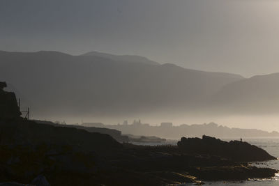 Scenic view of silhouette mountains against sky