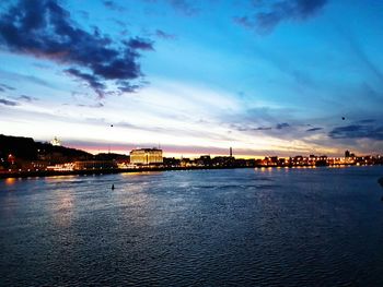 View of city at waterfront during sunset