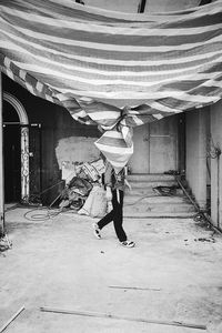 Full length side view of man standing against building