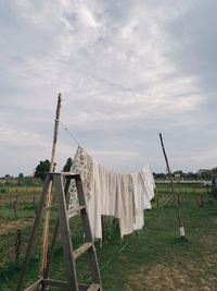 Rear view of woman standing on field against sky