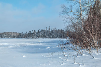 Frozen lake against sky during winter