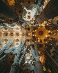 Low angle view of illuminated chandelier hanging in building