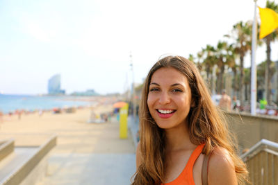 Portrait of smiling young woman at beach