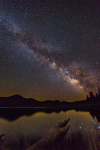 Scenic view of lake against star field at night