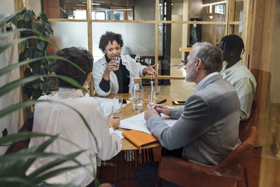 Young businesswoman discussing with colleagues in office