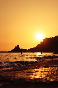 Scenic view of sea against orange sky