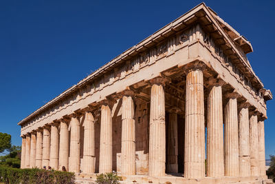 Low angle view of historical building against clear blue sky