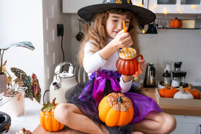 Portrait of young woman with pumpkin