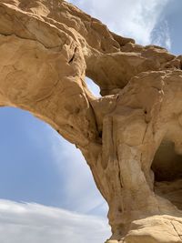 Low angle view of rock formation against sky